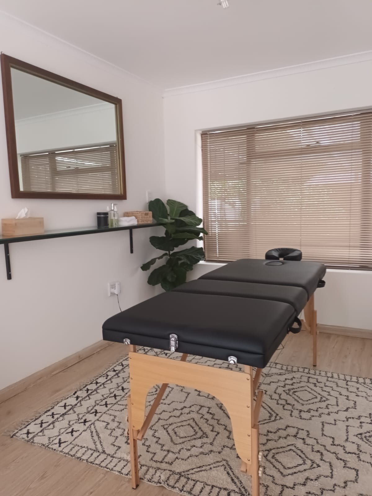The Impulse Alignment studio with a treatment table and warm natural light
